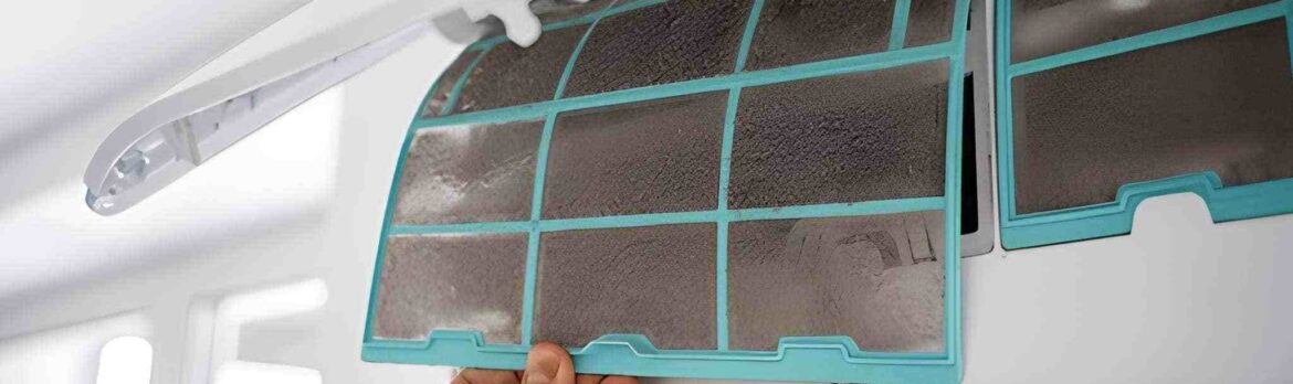 Heavily caked AC filter removed from a split unit showing dense dust and grime in Dubai home